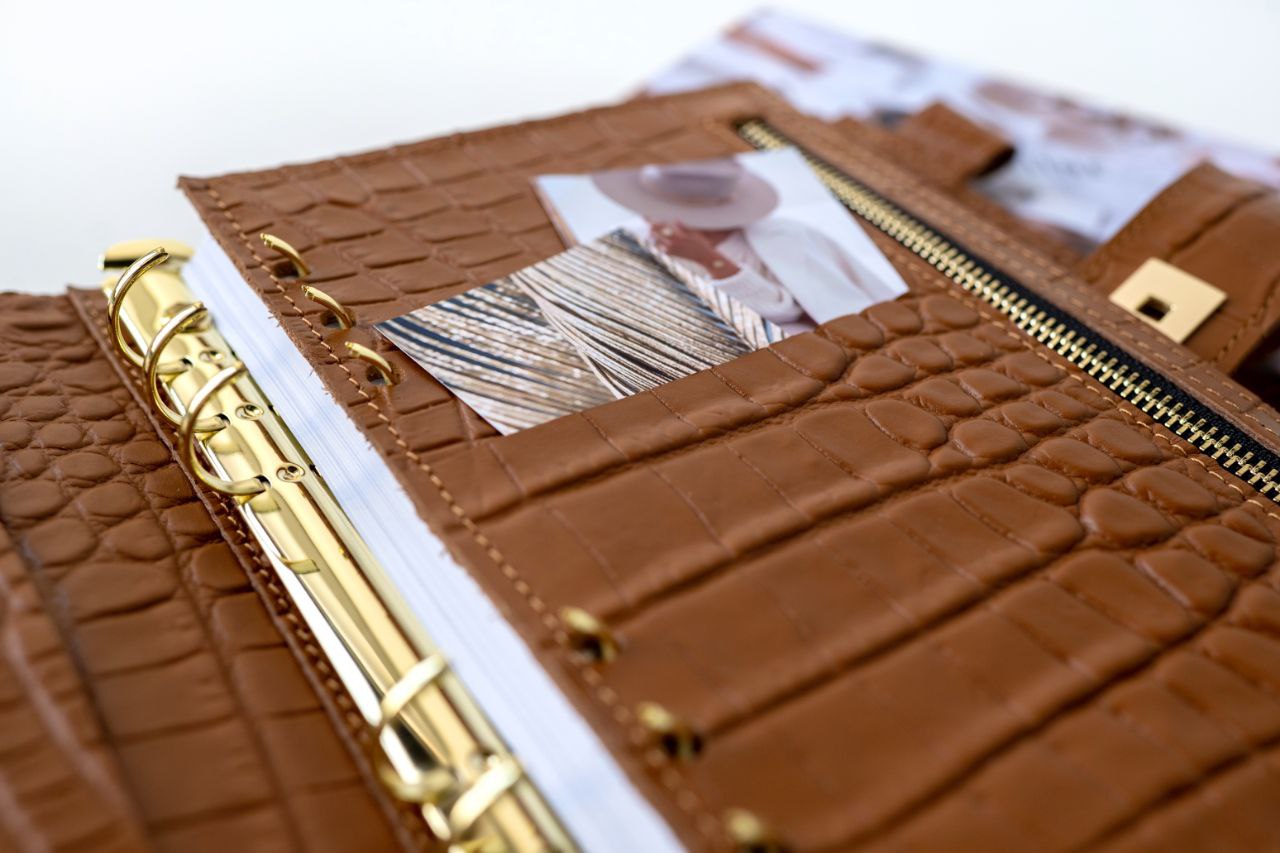 Close-up of rare brown leather A5 notebook cover with binder rings and photo pocket.