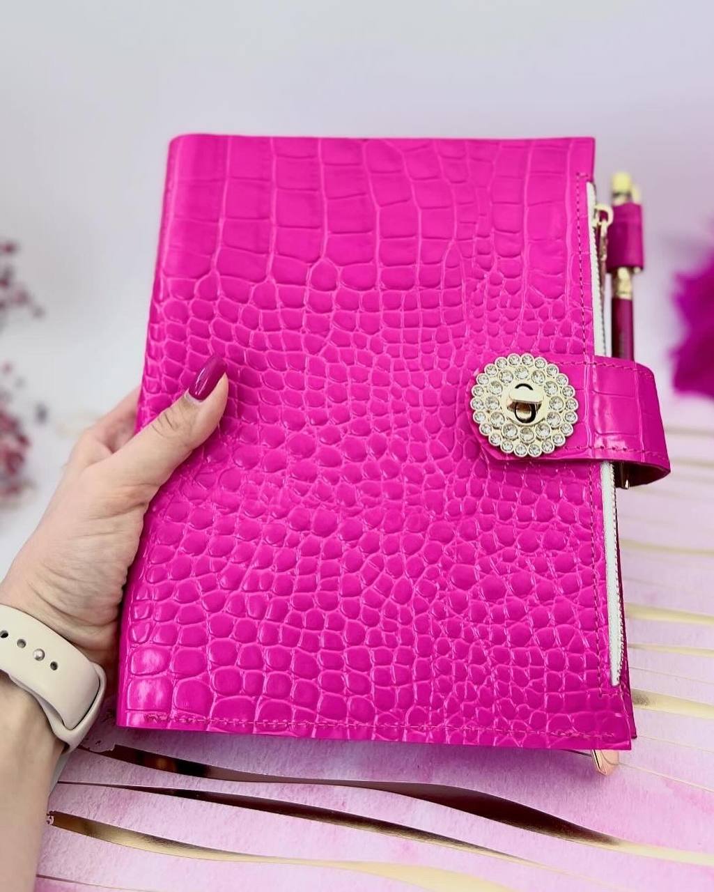 Cyprus, Limassol. Hot pink leather notebook cover A5 with big gold binder. Cover for A4 and A5 documents format.