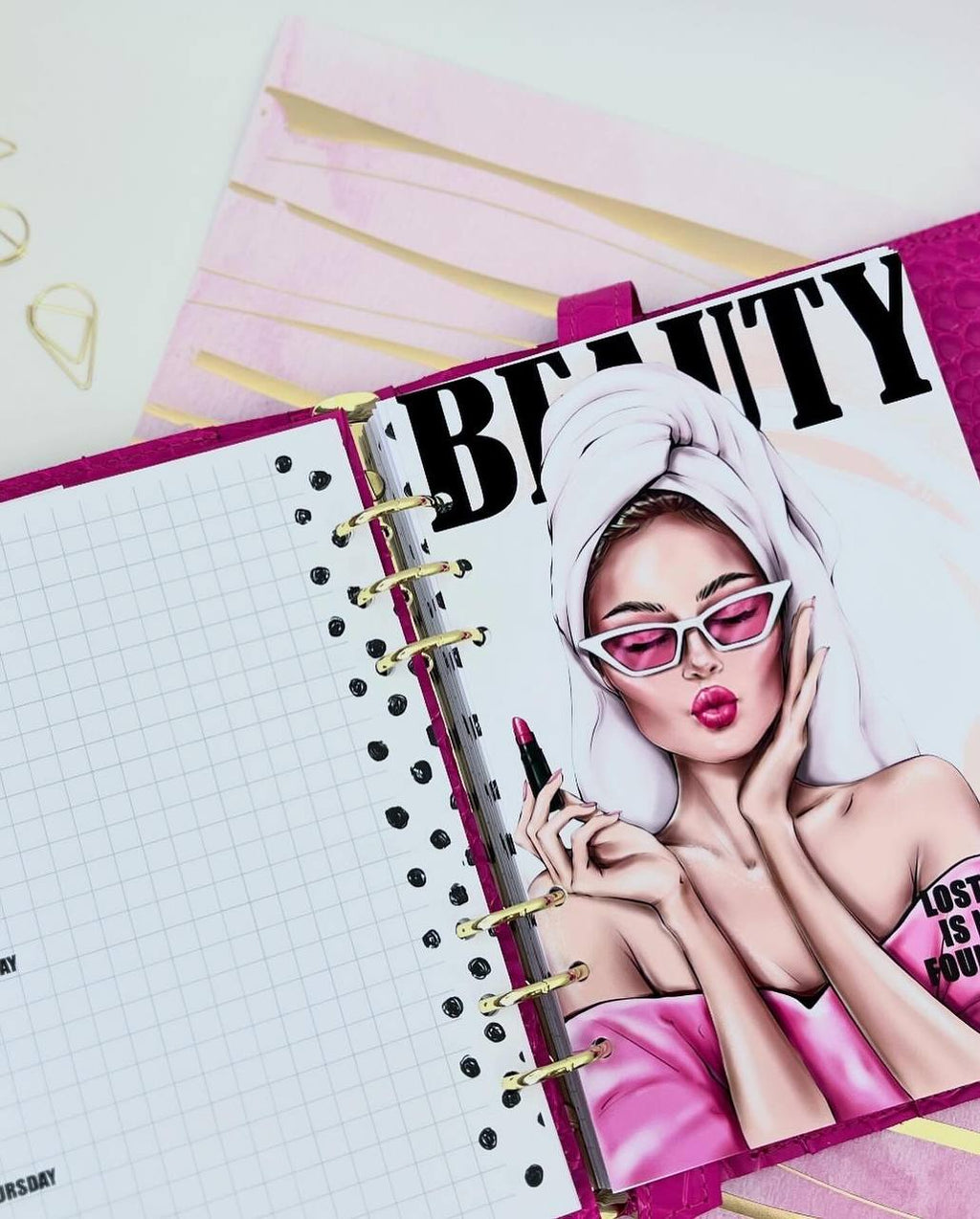 Cyprus, Limassol. Hot pink leather notebook cover A5 with big gold binder. Cover for A4 and A5 documents format.